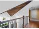 Upper hallway with vaulted ceiling, wood flooring and metal railing at 729 Main Street, Windermere, FL 34786