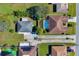 Aerial view showcasing a single-story home and a neighborhood pool at 905 Gascony Ct, Kissimmee, FL 34759