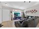 Spacious living room featuring a large sectional sofa and a beautiful Christmas tree at 905 Gascony Ct, Kissimmee, FL 34759