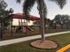 Shaded playground with play structures and slides at 905 Gascony Ct, Kissimmee, FL 34759