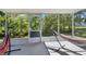 Relaxing screened porch with two hammocks and backyard view at 905 Gascony Ct, Kissimmee, FL 34759