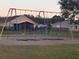 Four-seat swing set in a grassy playground area at 905 Gascony Ct, Kissimmee, FL 34759