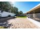 Large backyard with brick pavers, lush lawn, and privacy fence at 1032 Tawny Eagle Dr, Groveland, FL 34736