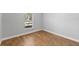 Well-lit bedroom featuring wood-look tile flooring and a window at 1032 Tawny Eagle Dr, Groveland, FL 34736