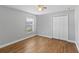 Bright bedroom with wood-look tile flooring and double doors at 1032 Tawny Eagle Dr, Groveland, FL 34736