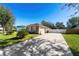 One-story house with a brown roof, gray siding, and driveway at 1032 Tawny Eagle Dr, Groveland, FL 34736