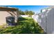 Landscaped side yard with privacy fence and AC unit at 1032 Tawny Eagle Dr, Groveland, FL 34736
