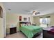 Spacious bedroom with king-size bed and large window at 12876 Sw 64Th Cir, Ocala, FL 34473