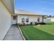 House exterior showcasing manicured lawn and walkway at 12876 Sw 64Th Cir, Ocala, FL 34473
