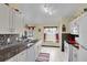 Kitchen boasts granite countertops and white cabinetry at 12876 Sw 64Th Cir, Ocala, FL 34473