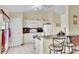 Kitchen with white cabinets, granite counters, and breakfast bar at 12876 Sw 64Th Cir, Ocala, FL 34473