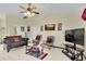 Living room with two armchairs and a large TV at 12876 Sw 64Th Cir, Ocala, FL 34473