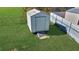 White storage shed with a wooden ramp at 12876 Sw 64Th Cir, Ocala, FL 34473