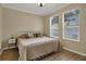 Bright bedroom with king-size bed and two windows at 14042 Sparkling Cove Ln # 606, Windermere, FL 34786
