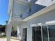 Rear view of a two-story house featuring a covered patio and sliding glass doors at 14716 Yorkshire Run Dr, Orlando, FL 32828