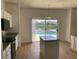 Kitchen with island, stainless steel appliances, and view of pool at 14716 Yorkshire Run Dr, Orlando, FL 32828