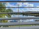 Serene lake view seen through the window blinds at 14716 Yorkshire Run Dr, Orlando, FL 32828