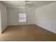 Bright living room with wood-look tile flooring and ceiling fan at 14716 Yorkshire Run Dr, Orlando, FL 32828