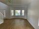 Bright living room with wood-look floors and bay windows at 14716 Yorkshire Run Dr, Orlando, FL 32828