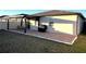 Backyard patio with covered lanai and grill at 161 Andreas St, Winter Haven, FL 33881
