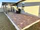 Covered patio with pavers, grill, and seating area at 161 Andreas St, Winter Haven, FL 33881