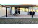 Covered patio with seating area and grill at 161 Andreas St, Winter Haven, FL 33881