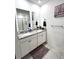 Double vanity bathroom with granite countertop and walk-in shower at 161 Andreas St, Winter Haven, FL 33881