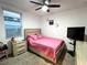 Bedroom with a pink bedspread, ceiling fan, and TV at 161 Andreas St, Winter Haven, FL 33881