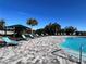 Community pool with lounge chairs, shade umbrella, and a playground at 161 Andreas St, Winter Haven, FL 33881