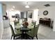 Dining room with a round glass table and green chairs at 161 Andreas St, Winter Haven, FL 33881