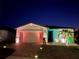 Attractive one-story home with colorful nighttime lighting and landscaping at 161 Andreas St, Winter Haven, FL 33881