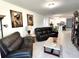 Spacious living room with leather reclining furniture and tile floors at 161 Andreas St, Winter Haven, FL 33881