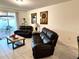 Relaxing living room with leather furniture, tile floors, and view of backyard at 161 Andreas St, Winter Haven, FL 33881