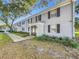 Gray brick building with walkway, landscaping, and parking at 163 Lewfield Cir, Winter Park, FL 32792