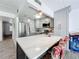 Modern kitchen with gray cabinets, quartz countertops and a breakfast bar at 163 Lewfield Cir, Winter Park, FL 32792