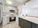Modern kitchen with gray cabinets, quartz countertops, and stainless steel appliances at 163 Lewfield Cir, Winter Park, FL 32792