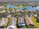 Aerial view of houses with solar panels and a lake at 200 Grand Canal Dr, Kissimmee, FL 34759