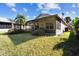 Home with screened patio, grassy yard, and lush landscaping at 200 Grand Canal Dr, Kissimmee, FL 34759