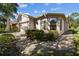 Tan house with paved walkway, landscaping, and large windows at 200 Grand Canal Dr, Kissimmee, FL 34759