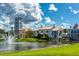 Community lake with fountain and picturesque buildings at 200 Grand Canal Dr, Kissimmee, FL 34759