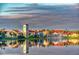 Lakefront view of charming townhomes reflecting in calm water at 200 Grand Canal Dr, Kissimmee, FL 34759