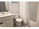 Clean bathroom with tub shower combo, white vanity, and gray flooring at 2914 Scarlett Dr, Saint Cloud, FL 34772
