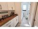 Laundry room with butcher block countertop and white cabinets at 2914 Scarlett Dr, Saint Cloud, FL 34772