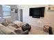 Relaxing living room featuring a large sectional sofa and a mounted TV at 2914 Scarlett Dr, Saint Cloud, FL 34772