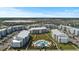 Aerial view of apartment community featuring a pool, lake, and multiple buildings at 3151 Paradox Cir # 201, Kissimmee, FL 34746