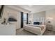Bright bedroom featuring a king-size bed and large artwork at 3151 Paradox Cir # 201, Kissimmee, FL 34746