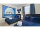 Themed bedroom with twin beds, featuring a large mural and stylish decor at 3151 Paradox Cir # 201, Kissimmee, FL 34746