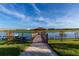 Wooden dock with gazebo offering kayaks and scenic lake views at 3151 Paradox Cir # 201, Kissimmee, FL 34746