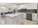 Modern kitchen with white cabinets, quartz countertops and island at 3151 Paradox Cir # 201, Kissimmee, FL 34746