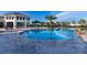 Resort-style pool with ample lounge chairs and a nearby clubhouse at 3151 Paradox Cir # 201, Kissimmee, FL 34746